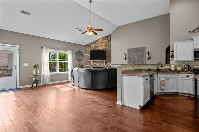 7211 Deervalley Dr, Fairview, TN 37062 - kitchen featuring a ceiling fan, stainless steel microwave, a peninsula, high vaulted ceiling, and white cabinetry