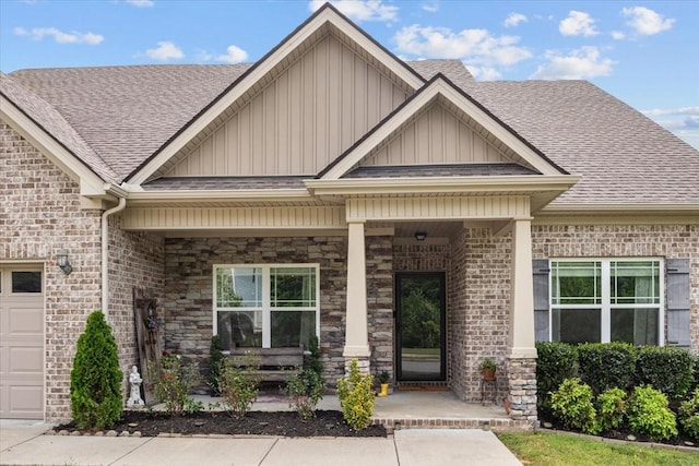 7211 Deervalley Dr, Fairview, TN 37062 - property entrance with board and batten siding, a shingled roof, covered porch, brick siding, and stone siding