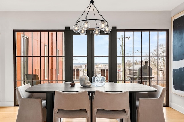 3800 Dakota Ave, Nashville, TN 37209 - dining room with french doors, a chandelier, light wood-style flooring, and plenty of natural light