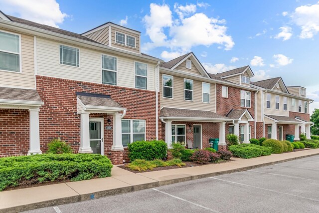 5008 Fennel Ct, Spring Hill, TN 37174 - townhome / multi-family property with brick siding, uncovered parking, and a residential view