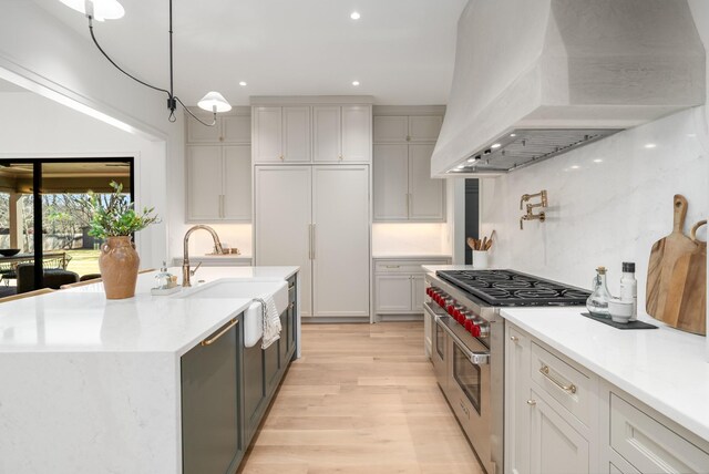 520 Mansion Dr, Brentwood, TN 37027 - kitchen featuring range with two ovens, premium range hood, light wood-type flooring, a sink, and recessed lighting