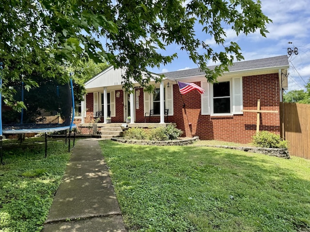 111 Rainbow St, Clarksville, TN 37042 - single story home with a trampoline, brick siding, covered porch, and roof with shingles