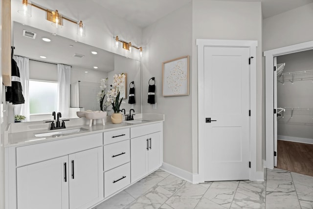 2507H Strong St, Columbia, TN 38401 - bathroom featuring marble look tiles, baseboards, double vanity, a walk in closet, and recessed lighting