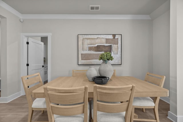 2507H Strong St, Columbia, TN 38401 - dining area featuring baseboards, wood finished floors, and ornamental molding