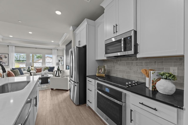 2507H Strong St, Columbia, TN 38401 - kitchen with appliances with stainless steel finishes, open floor plan, white cabinetry, decorative backsplash, and recessed lighting