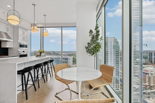 1616 W End Ave Unit 2008, Nashville, TN 37203 - dining area featuring a view of city, light wood-style floors, and expansive windows