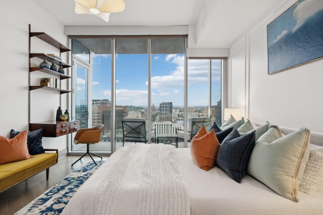 1616 W End Ave Unit 2008, Nashville, TN 37203 - bedroom featuring access to exterior, a city view, wood finished floors, and a wall of windows