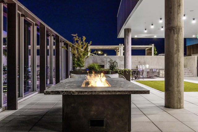 1616 W End Ave Unit 2008, Nashville, TN 37203 - patio at twilight featuring an outdoor fire pit, a patio area, and grilling area