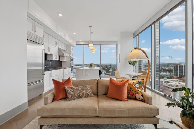 1616 W End Ave Unit 2008, Nashville, TN 37203 - living area featuring wood finished floors, a wall of windows, and recessed lighting