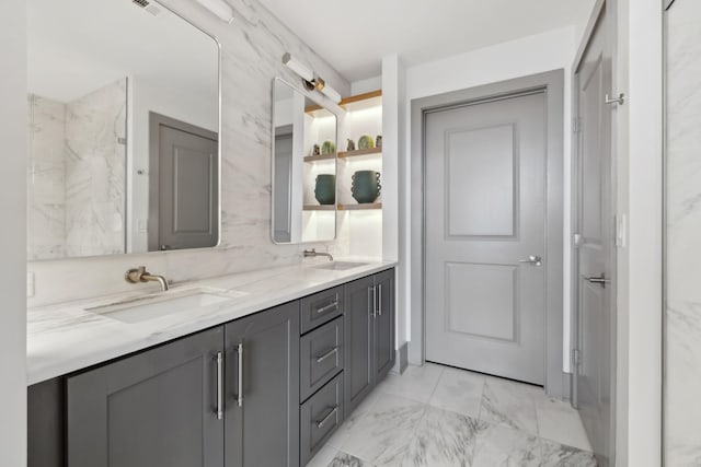 1616 W End Ave Unit 2008, Nashville, TN 37203 - bathroom featuring double vanity, marble finish floors, and backsplash
