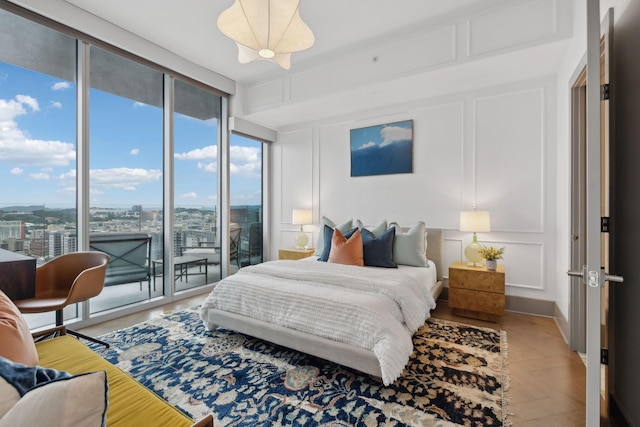 1616 W End Ave Unit 2008, Nashville, TN 37203 - bedroom featuring a decorative wall, access to outside, a wall of windows, and a view of city