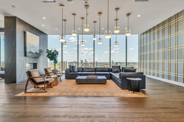 1616 W End Ave Unit 2008, Nashville, TN 37203 - living room with wallpapered walls, wood-type flooring, a wall of windows, and a fireplace