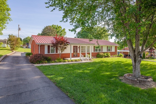 206 Crestland Dr, Columbia, TN 38401 - single story home featuring brick siding, a front lawn, metal roof, a standing seam roof, and asphalt driveway