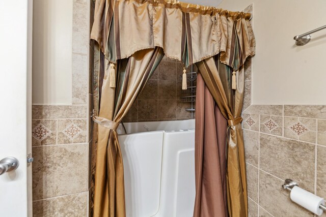 206 Crestland Dr, Columbia, TN 38401 - bathroom featuring curtained shower, a bathtub, and tile walls