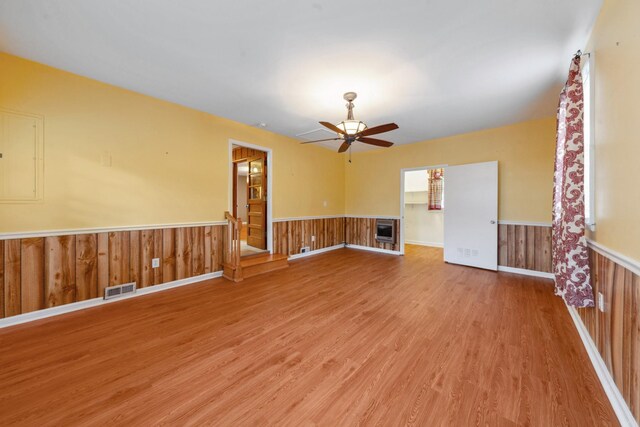 206 Crestland Dr, Columbia, TN 38401 - spare room featuring wood finished floors, wainscoting, ceiling fan, and wood walls