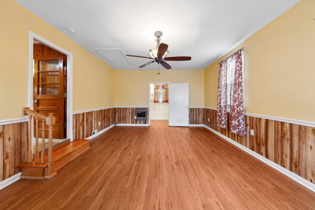206 Crestland Dr, Columbia, TN 38401 - unfurnished living room featuring wainscoting, a ceiling fan, wood finished floors, wooden walls, and attic access