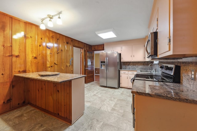 206 Crestland Dr, Columbia, TN 38401 - kitchen featuring appliances with stainless steel finishes, wood walls, backsplash, a sink, and white cabinets