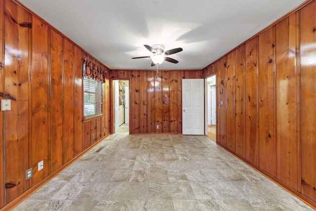206 Crestland Dr, Columbia, TN 38401 - spare room with wooden walls, a ceiling fan, stone finish floors, and baseboards