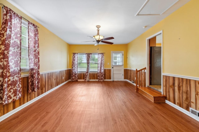 206 Crestland Dr, Columbia, TN 38401 - empty room featuring wood finished floors, a wainscoted wall, attic access, a ceiling fan, and wood walls