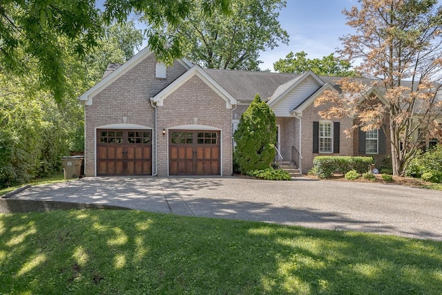 960 Caldwell Ln, Nashville, TN 37204 - view of front of house featuring driveway, brick siding, a garage, and a front yard