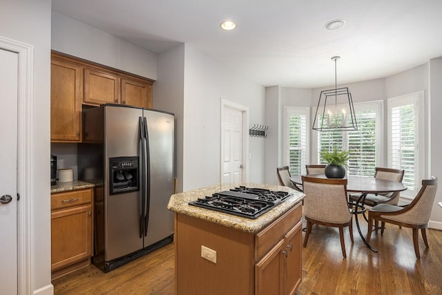 960 Caldwell Ln, Nashville, TN 37204 - kitchen with stainless steel fridge with ice dispenser, black gas cooktop, wood finished floors, brown cabinetry, and a center island