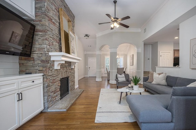 960 Caldwell Ln, Nashville, TN 37204 - living area with ornate columns, ceiling fan, arched walkways, a stone fireplace, and ornamental molding