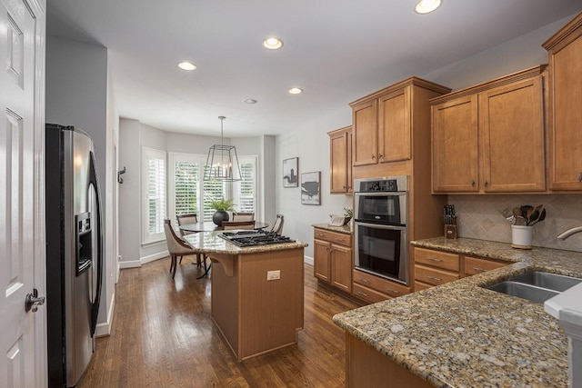 960 Caldwell Ln, Nashville, TN 37204 - kitchen featuring stainless steel appliances, a sink, brown cabinetry, recessed lighting, and baseboards
