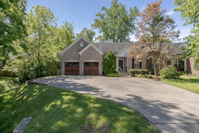 960 Caldwell Ln, Nashville, TN 37204 - view of front of property with driveway, a garage, brick siding, and a front yard