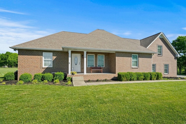 1020 Loganview Way, Springfield, TN 37172 - view of front facade with brick siding, a porch, a front lawn, and roof with shingles