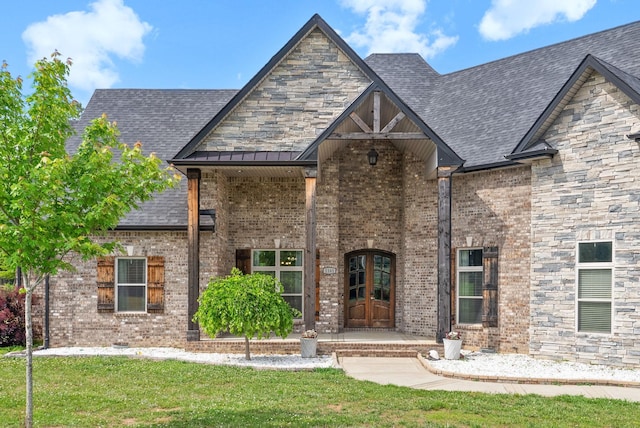 1161 Reda Dr, Clarksville, TN 37042 - view of front facade with a front yard, brick siding, french doors, and roof with shingles
