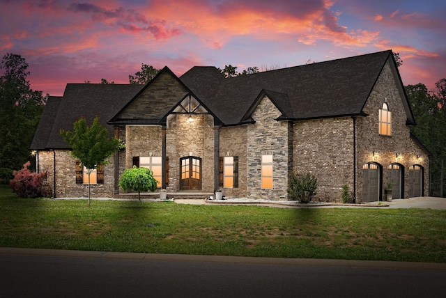1161 Reda Dr, Clarksville, TN 37042 - french country home featuring a lawn, concrete driveway, a shingled roof, an attached garage, and brick siding