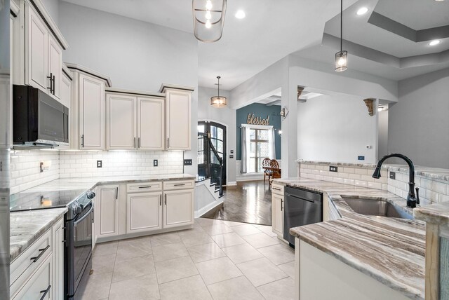 1161 Reda Dr, Clarksville, TN 37042 - kitchen with black appliances, a sink, backsplash, arched walkways, and recessed lighting