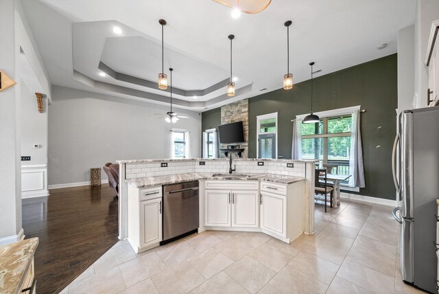 1161 Reda Dr, Clarksville, TN 37042 - kitchen with appliances with stainless steel finishes, a sink, a ceiling fan, light stone counters, and white cabinets
