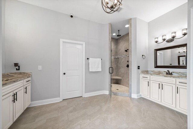 1161 Reda Dr, Clarksville, TN 37042 - bathroom featuring a stall shower, vanity, baseboards, and a chandelier