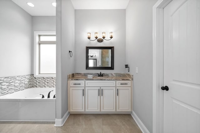 1161 Reda Dr, Clarksville, TN 37042 - bathroom featuring baseboards, vanity, and a garden tub