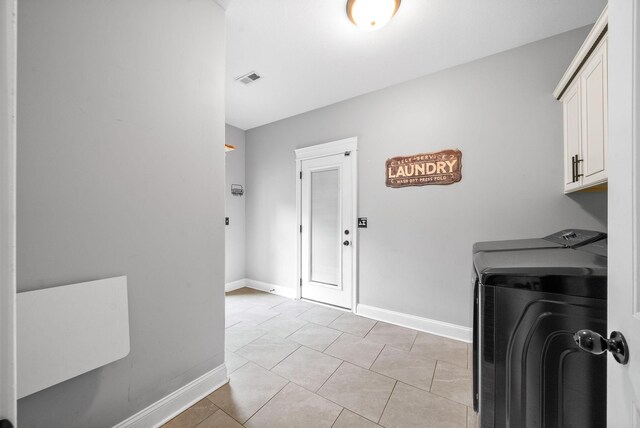 1161 Reda Dr, Clarksville, TN 37042 - laundry room with separate washer and dryer, cabinet space, baseboards, and light tile patterned floors