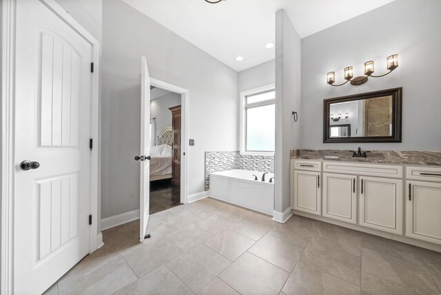 1161 Reda Dr, Clarksville, TN 37042 - full bath with a garden tub, connected bathroom, vanity, baseboards, and recessed lighting