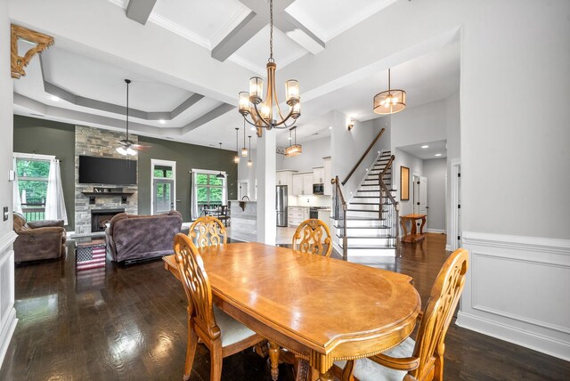 1161 Reda Dr, Clarksville, TN 37042 - dining area with a ceiling fan, wood finished floors, a fireplace, stairway, and a chandelier