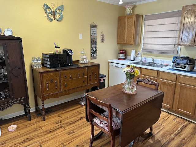 1140 Brittany Park Ln, Antioch, TN 37013 - kitchen featuring dishwasher, a sink, light wood finished floors, crown molding, and light countertops