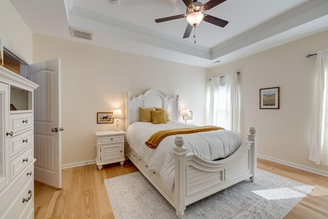 979 Carnation Dr, Spring Hill, TN 37174 - bedroom featuring a tray ceiling, crown molding, light wood-style floors, and baseboards