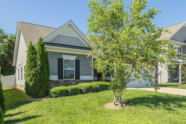 979 Carnation Dr, Spring Hill, TN 37174 - view of front facade featuring concrete driveway, a front yard, and stone siding