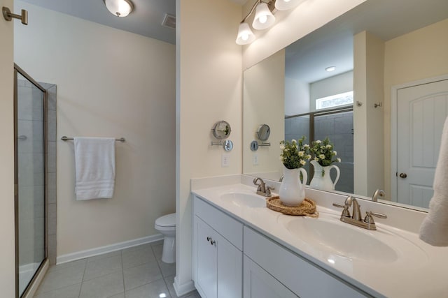 979 Carnation Dr, Spring Hill, TN 37174 - bathroom with double vanity, toilet, tile patterned floors, a tile shower, and baseboards