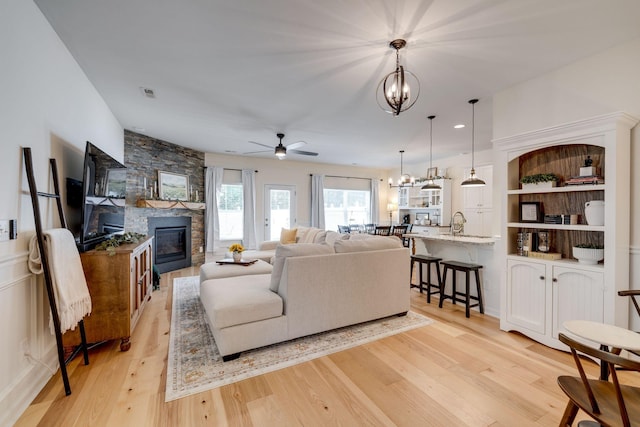 979 Carnation Dr, Spring Hill, TN 37174 - living area featuring a chandelier, a fireplace, light wood finished floors, and a ceiling fan