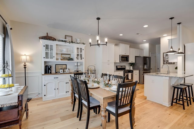979 Carnation Dr, Spring Hill, TN 37174 - dining room featuring a chandelier, light wood-style floors, wainscoting, and recessed lighting