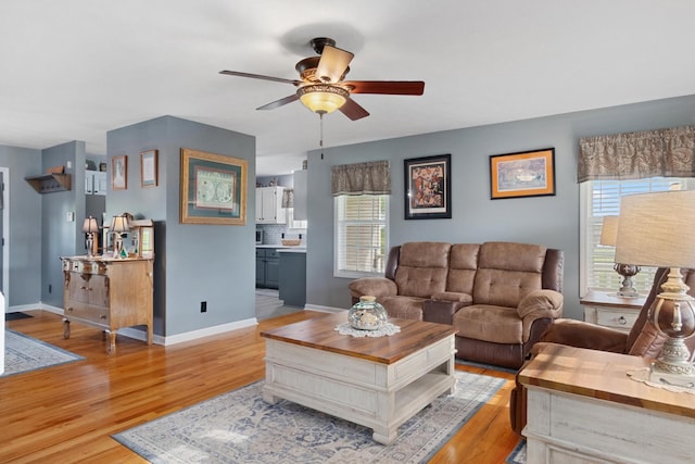 6928 Hoover Mason Ln, Mount Pleasant, TN 38474 - living area with plenty of natural light, a ceiling fan, light wood-style floors, and baseboards