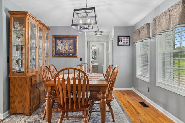 6928 Hoover Mason Ln, Mount Pleasant, TN 38474 - dining space featuring a chandelier, light wood-type flooring, and baseboards