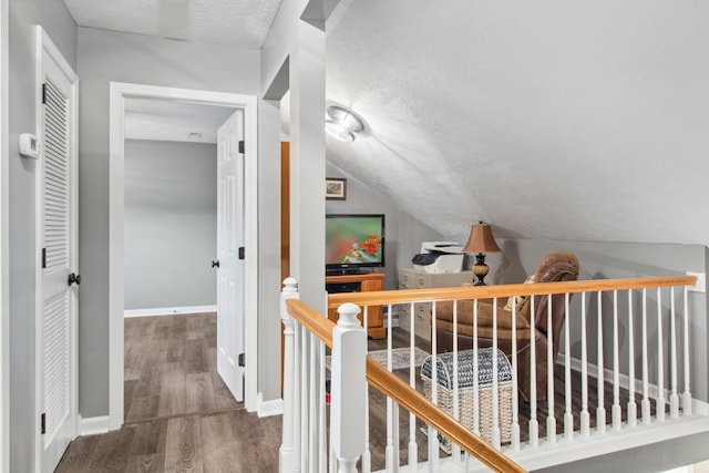 6928 Hoover Mason Ln, Mount Pleasant, TN 38474 - hallway featuring a textured ceiling, an upstairs landing, wood finished floors, baseboards, and lofted ceiling
