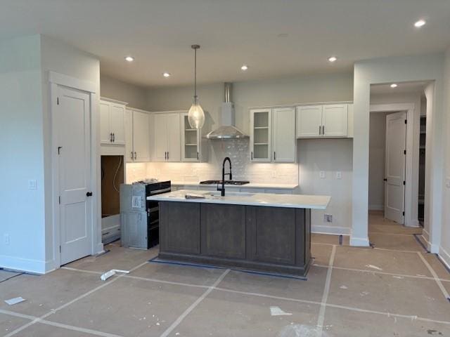 4605 Hessey Rd, Mount Juliet, TN 37122 - kitchen with wall chimney exhaust hood, white cabinetry, tasteful backsplash, an island with sink, and light countertops