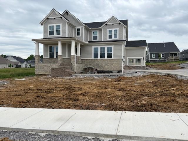 4605 Hessey Rd, Mount Juliet, TN 37122 - craftsman house with stone siding, a residential view, covered porch, and central air condition unit