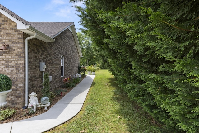 147 Crimson Dr, Winchester, TN 37398 - view of home's exterior with a lawn, brick siding, and roof with shingles